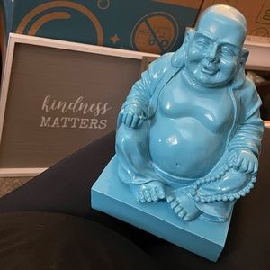 Smiling Teal Buddha by Three Hands Corp